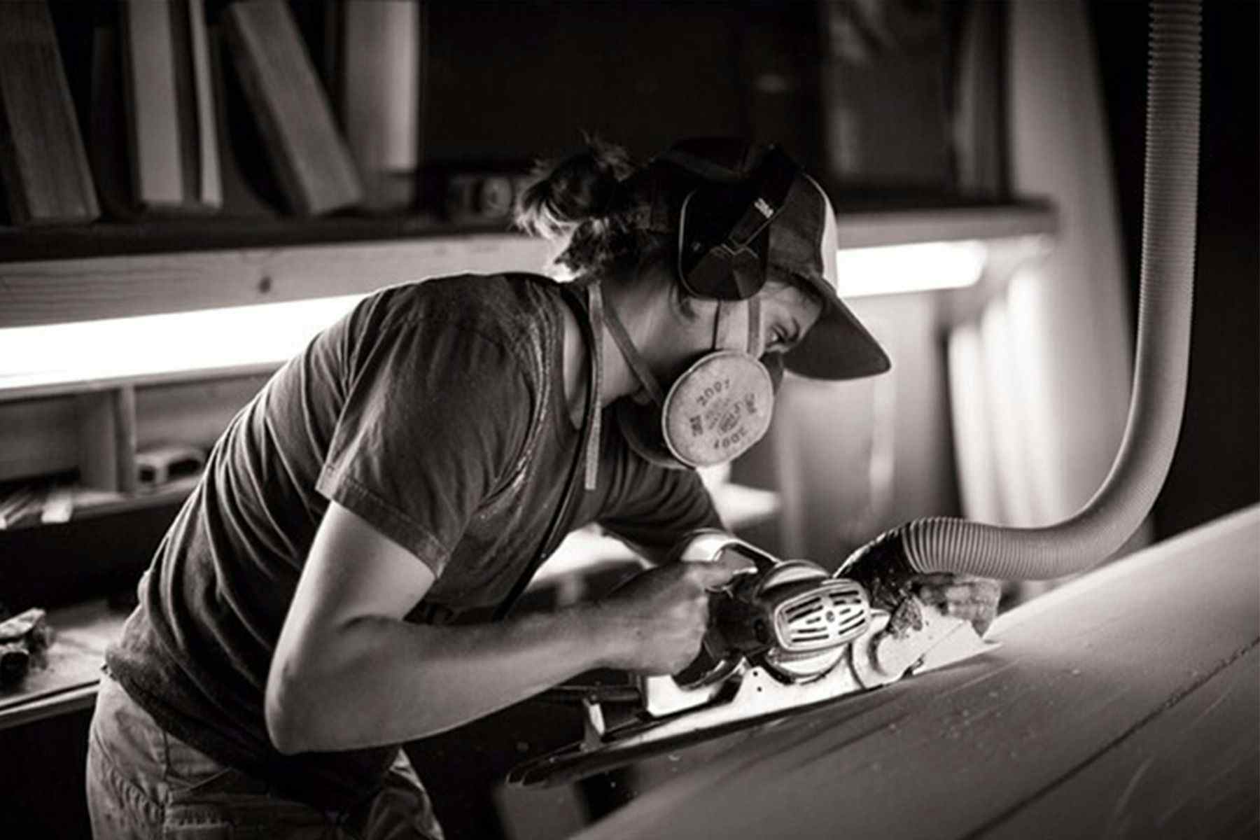 surfboard shaper Christine Brailsford Caro of furrow surfcraft shaping a surfboard by hand with a power planer