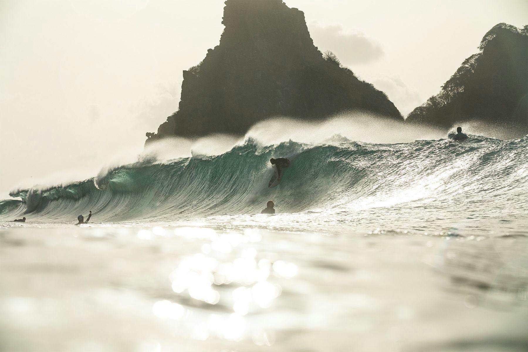 surfer dropping into a wave at cacimba in brazil, by ana catarina