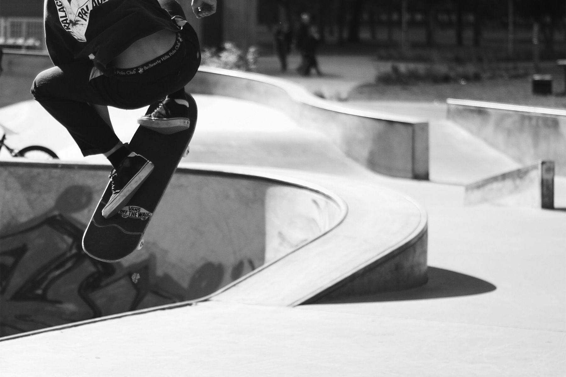 skateboarder popping an ollie out of a bowl in east london