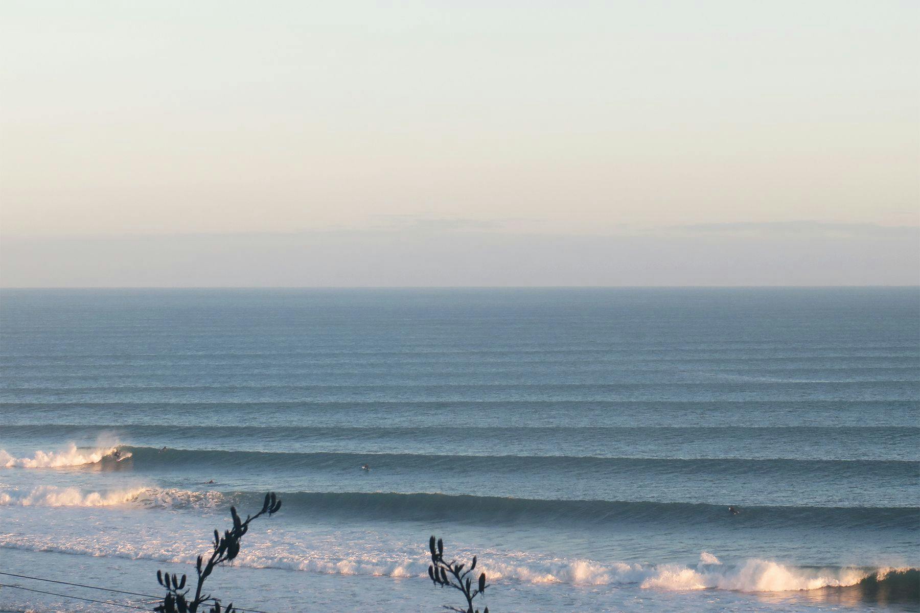 waves breaking down the left hand point break at raglan, new zealand