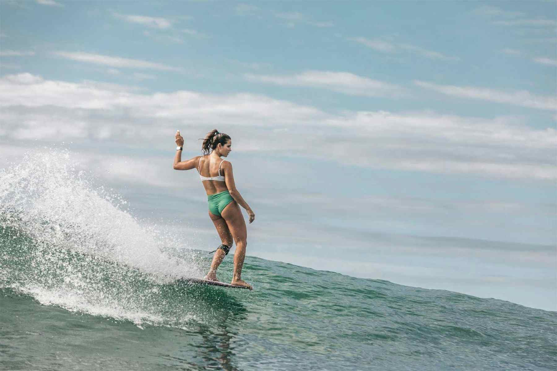 young woman noseriding a longboard, photographed by ana catarina