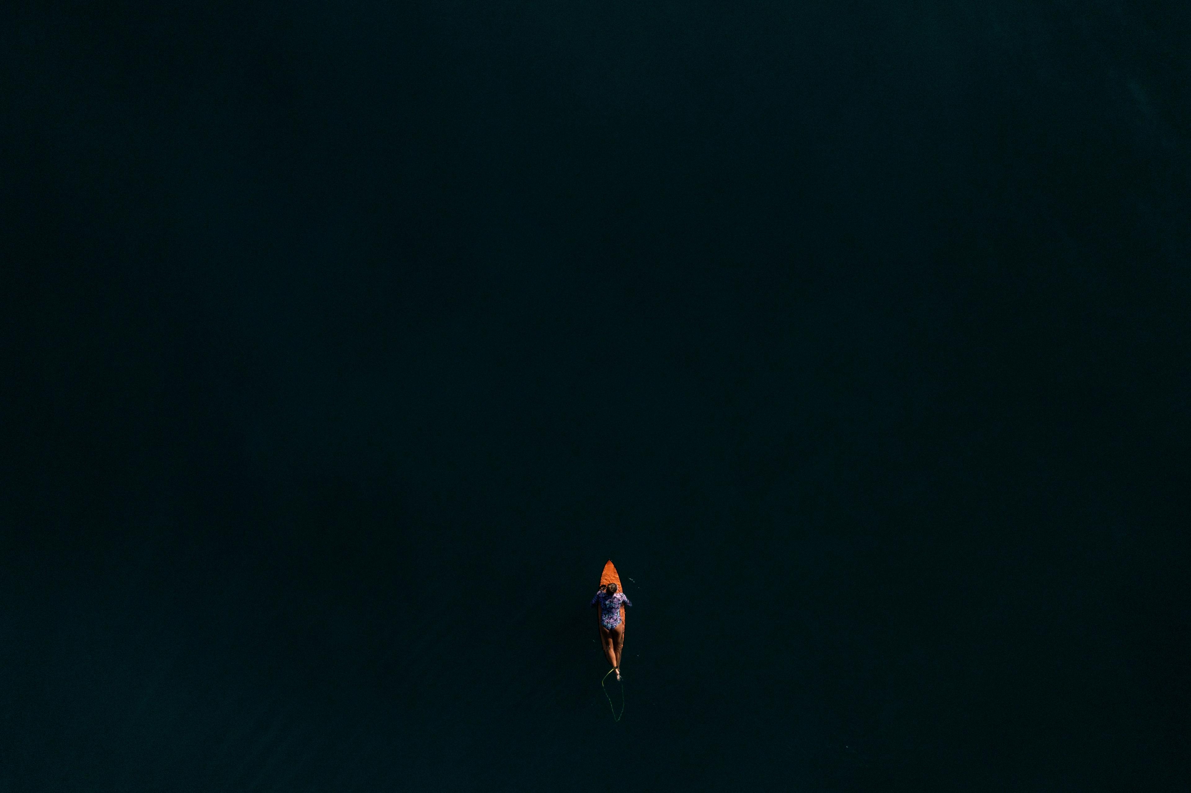 aerial photo of surfer maya gabiera paddling out