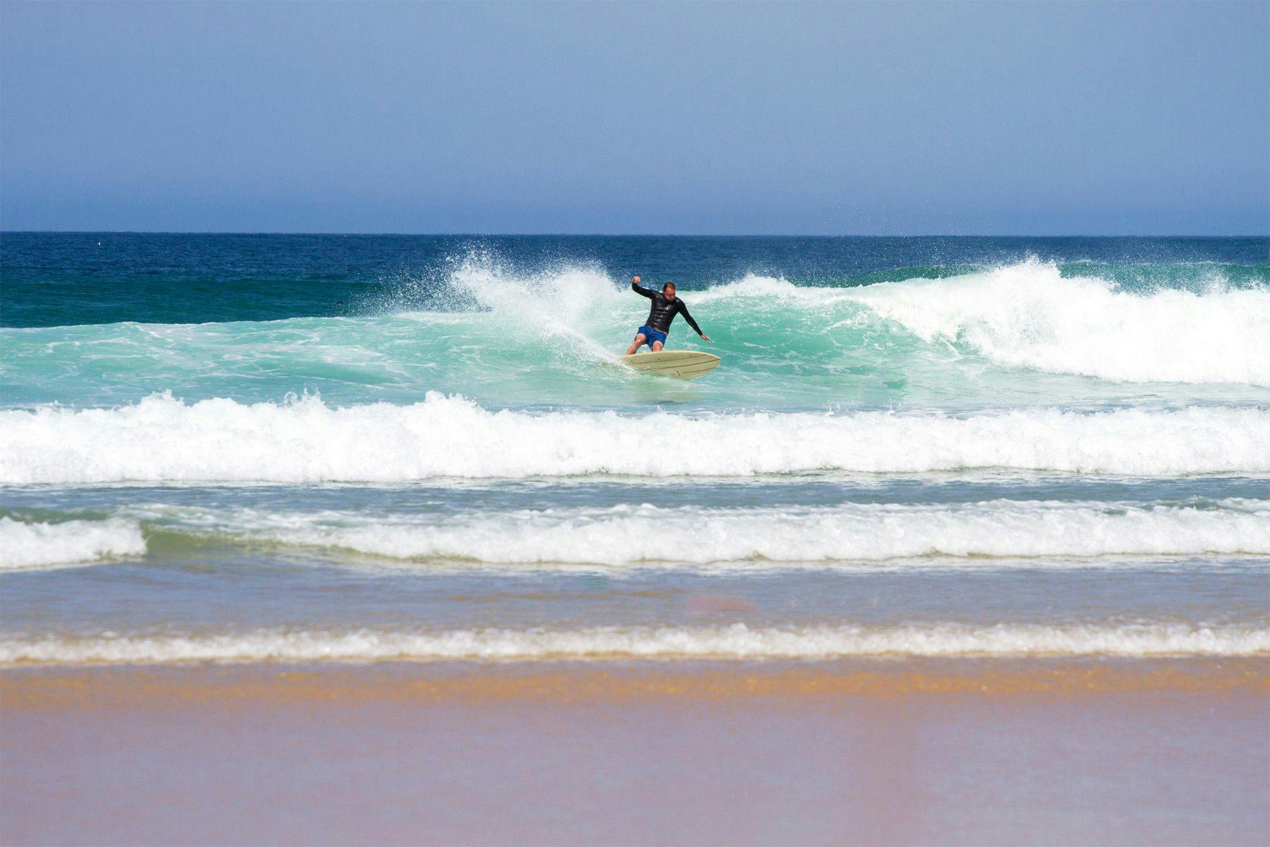 dan crockett of blue marine foundation surfing in cornwall on an otter wooden surfboard