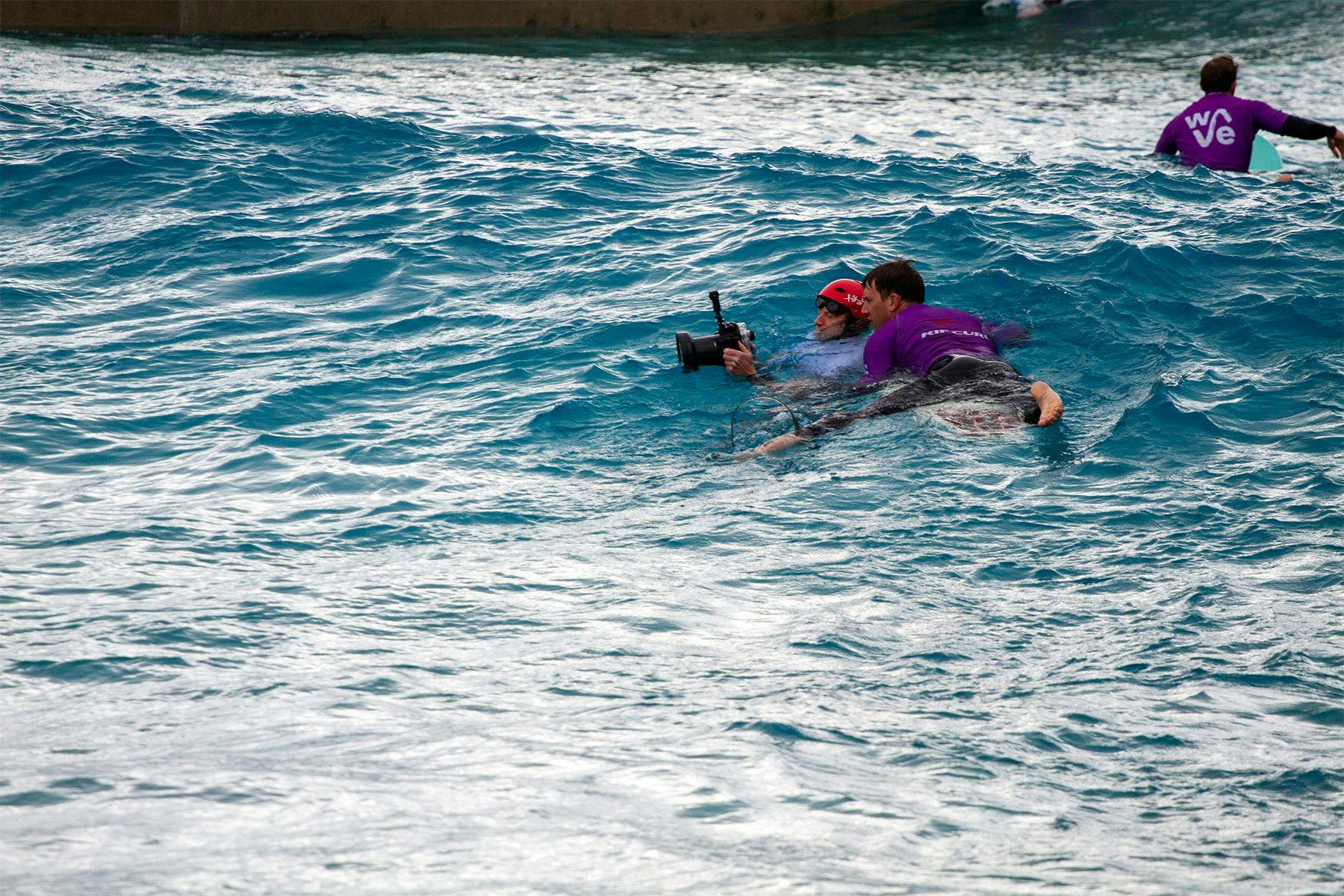 surfer and surf photographer reviewing images in water at the wave in bristol